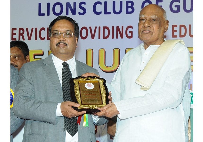 R. Pandurangan receiving a certificate of appreciation at a Lions Club event